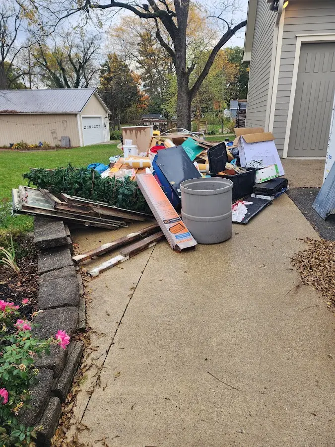Dumpster being loaded with debris for 3 Yard Dumpster Rental in Lumberton